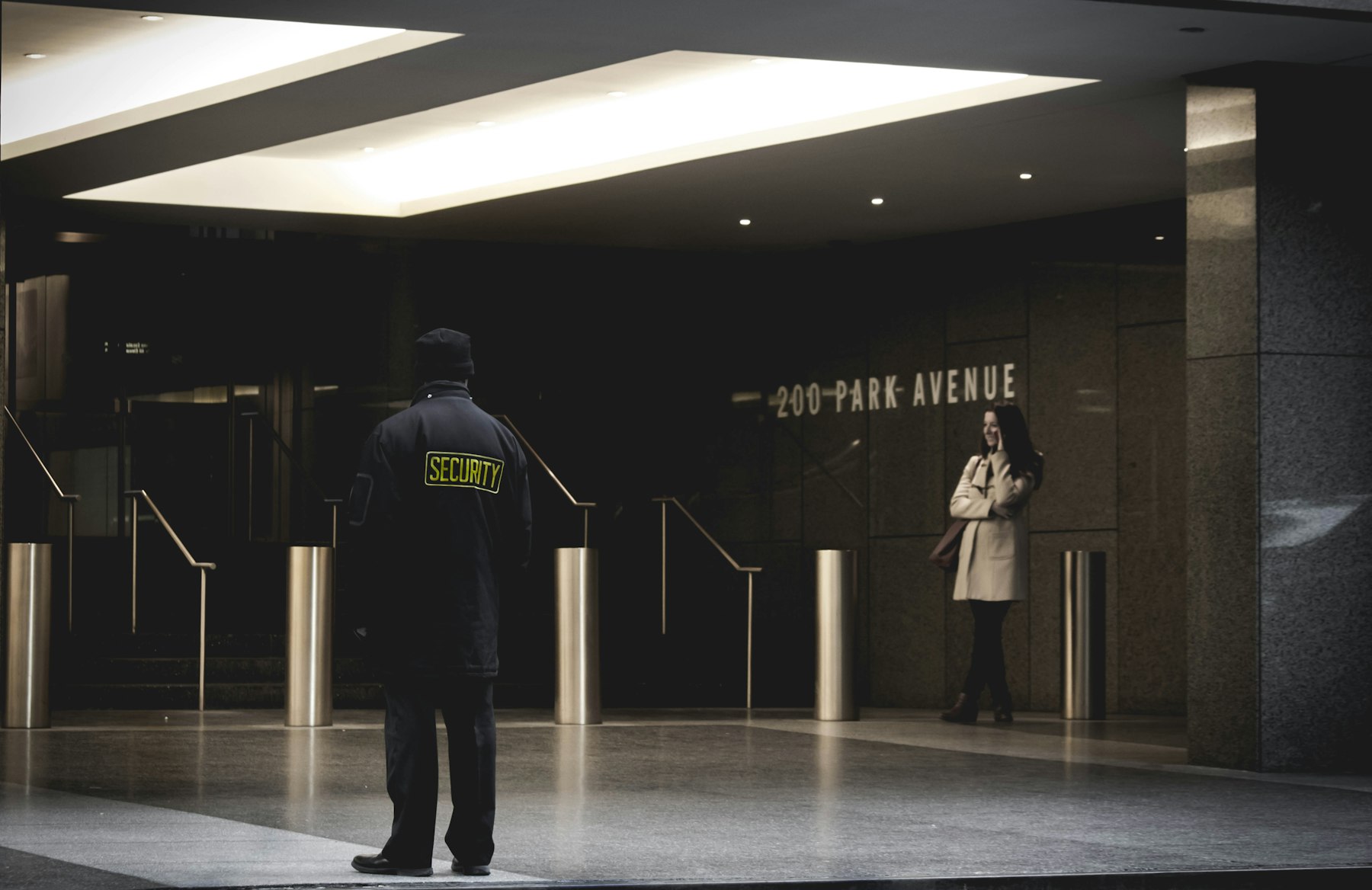 Uniformed security guard on duty in a commercial building lobby